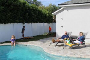 Family spending time by the pool in their yard. 